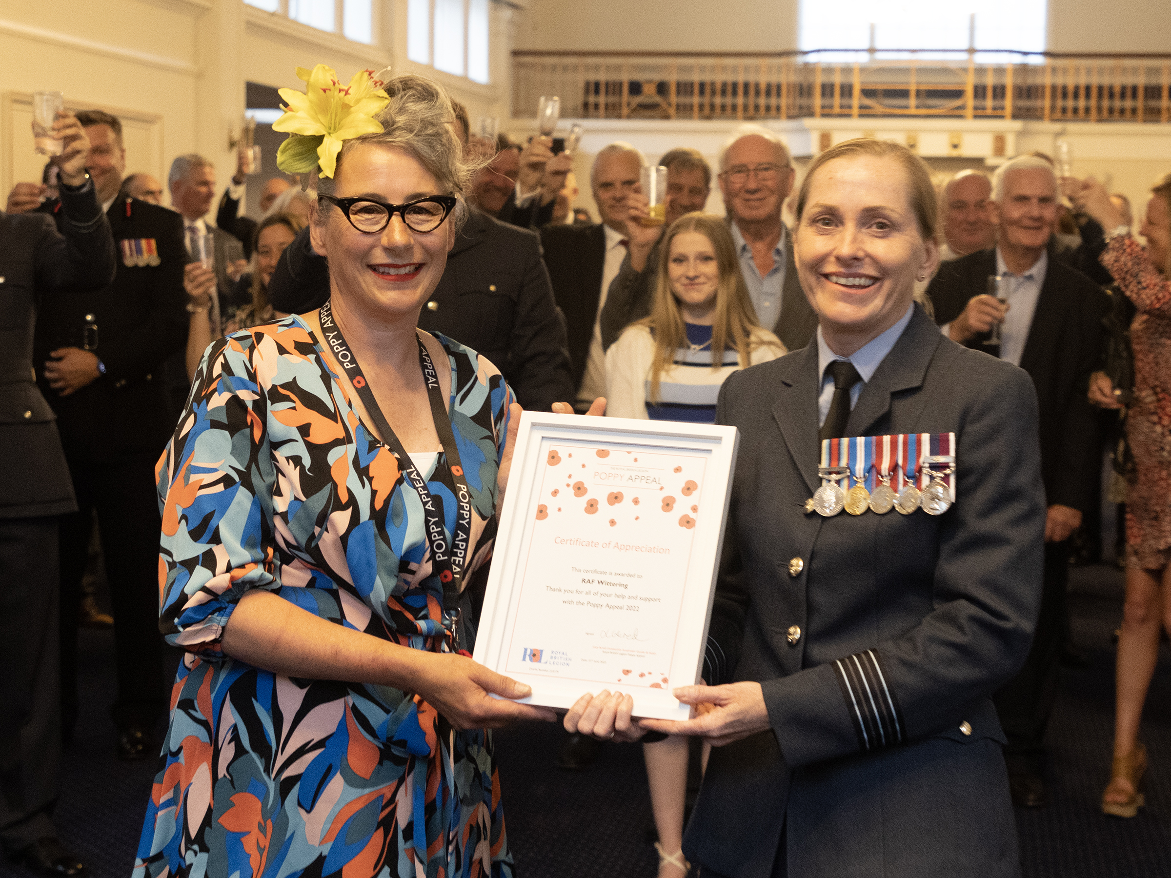 Lucy Acred, of the Royal British Legion, presents Station Commander Wing Commander Nikki Duncan with a Certificate of Appreciation for RAF Wittering